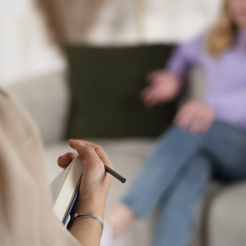 sided-view-young-girl-talking-therapist